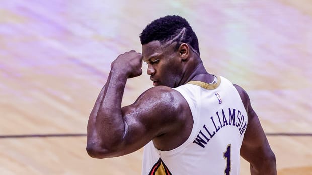 Zion Williamson flexes after making a shot.